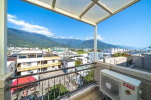 a balcony with a view of a city at Rain Sun Homestay in Ji'an