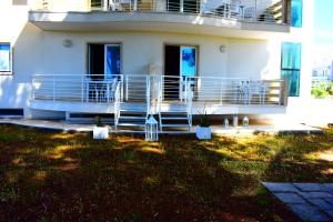 a white house with a balcony and a yard at MARIMAR - Apartments OTRANTO in Otranto +191 photos