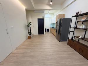 a hallway of a kitchen with a refrigerator at Si Sou Homestay in Nanxi +15 photos