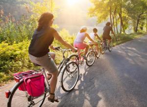a group of people riding bikes down a road at Residence Oasi del Delta in Taglio di Po