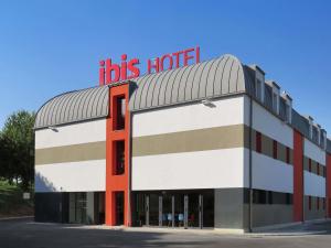 a building with a red sign on top of it at ibis Soissons in Soissons