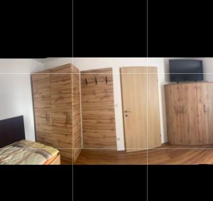 a bedroom with wooden cabinets and a bed in it at Haus Brandner Judenburg in Judenburg