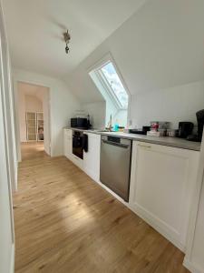 a kitchen with white cabinets and a window in it at Het Schuttershof in Hoogstraten +7 photos