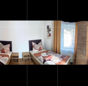 a bedroom with two beds and a window at Haus Brandner Judenburg in Judenburg +7 photos