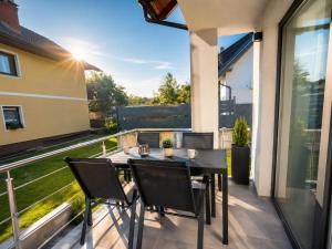 a patio with a table and chairs on a balcony at The River House in Mavčiče