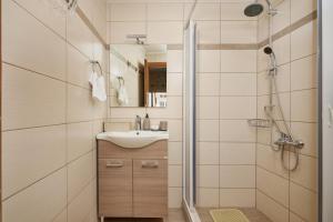 a bathroom with a sink and a shower at Chara Stone House in Kharasón +16 photos