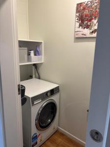 a washer and dryer in a small room at The Opera View Suite in Oamaru