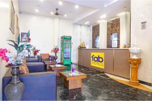 a lobby with couches and tables and ako hotels sign at FabHotel Golden Emerald in Pune