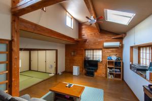 a living room with a ping pong table and a ceiling at 古民家一棟貸 鴨部巣 kamobese in Kochi