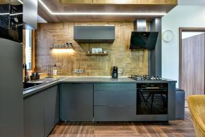 a kitchen with a counter and a stove top oven at Luxbor Villa in Eger
