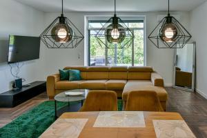 a living room with a couch and a table at Luxbor Villa in Eger