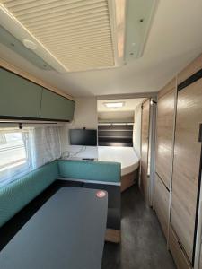 a small room with a couch and a bed at HelloHel klimatyzowane przyczepy Jastarnia Surf Kite Wind in Jastarnia +41 photos