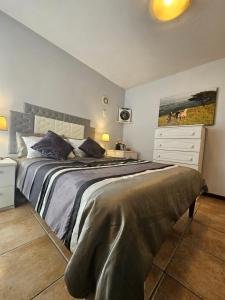 a bedroom with a large bed and a dresser at Marine View in Plettenberg Bay +14 photos