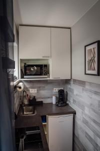 a small kitchen with a sink and a microwave at Apartment Nr 11 in Bremerhaven