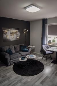 a living room with a couch and a table at Apartment Nr 11 in Bremerhaven +2 photos