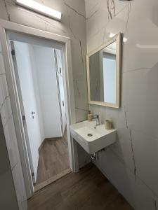 a white bathroom with a sink and a mirror at ThasosGoldenStay in Skala Potamias +15 photos
