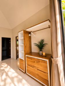 a room with a wooden dresser with a plant on it at Mirari Villa in Wok Tum +14 photos