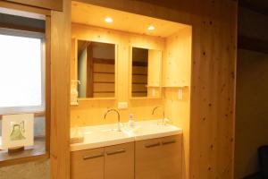 a bathroom with a sink and a mirror at Ichimaru Ryokan - Vacation STAY 59281v in Tenkawa