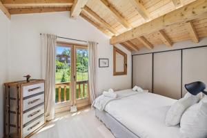 a bedroom with a bed and a window at Chalet Niva by Mrs Miggins in Lens