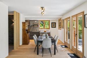 a kitchen and dining room with a table and chairs at Chalet Niva by Mrs Miggins in Lens