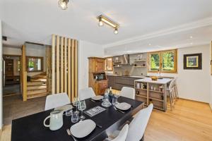 a kitchen and dining room with a table and chairs at Chalet Niva by Mrs Miggins in Lens +6 photos