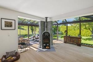 an open living room with a fireplace in a house at Chalet Niva by Mrs Miggins in Lens