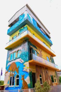 a building with a painting on the side of it at The Aussie House in Mahabalipuram