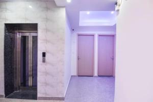 two doors in a building with purple at FabHotel Dwarka Heritage in New Delhi