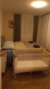 a small bedroom with two beds and a window at Apartman Provo in Široki Brijeg