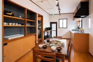 a kitchen with a wooden table in a room at 富士と宿と Fuji to Yado to in Fujiyoshida