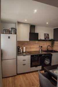 a kitchen with a white refrigerator and a stove at Apartment Claussen 2 in Bremerhaven