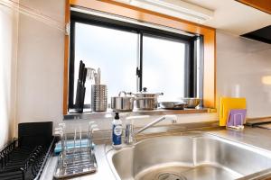 a kitchen with a sink and a window at 富士と宿と Fuji to Yado to in Fujiyoshida +18 photos