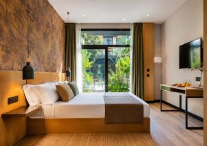 a bedroom with a large bed and a large window at Saman Hotel Boutique in Valencia