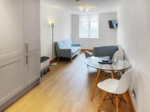 a living room with a table and chairs at Castleriggs Cottage - Uk45178 in Threlkeld