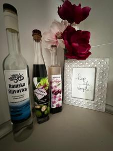 two bottles of wine sitting next to a box of flowers at Apartmani Ivana in Prozor +4 photos