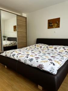 a bedroom with a bed and a large mirror at Apartmani Ivana in Prozor