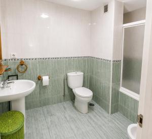 a bathroom with a toilet and a sink at Playa A Ribeira - Miño in Miño
