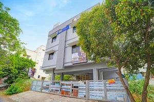 a building with a fence in front of it at FabHotel Nimalan Residency Tambaram in Chennai