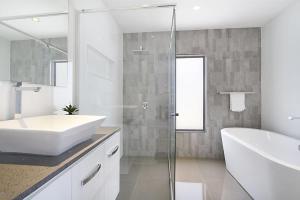 a bathroom with a sink and a tub and a shower at Buena Vista in Gold Coast +4 photos