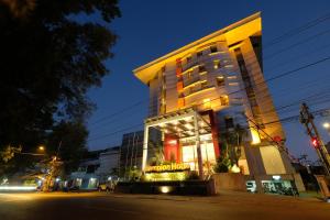 a building on a city street at night at Lampion Hotel Solo in Grogol