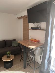 a living room with a table and a couch at Refuge de la Basilique in Charleville-Mézières +31 photos