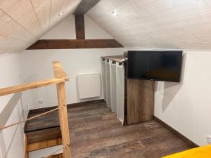 a room with a flat screen tv on the wall at Refuge de la Basilique in Charleville-Mézières