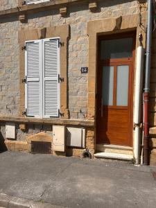 a brick building with a door and a window at Refuge de la Basilique in Charleville-Mézières