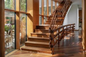 a staircase in a house with wooden floors and windows at Palanga Life Balance SPA Hotel in Palanga
