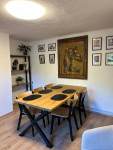 a dining room with a wooden table and chairs at Apartmán Železná panna in České Budějovice