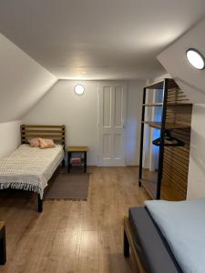 a bedroom with two beds and a room with a ladder at Apartmán Železná panna in České Budějovice