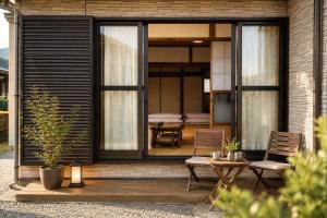a screened in porch of a house with a table and chairs at 富士と宿と Fuji to Yado to in Fujiyoshida