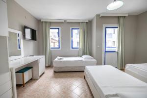 a hotel room with two beds and a sink at Sunpoint Hotel Bodrum in Bodrum City +98 photos