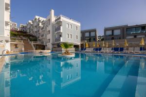 a swimming pool with a palm in the middle of a building at Sunpoint Hotel Bodrum in Bodrum City
