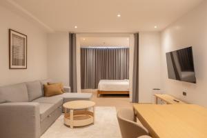 a living room with a couch and a table at Taupe Hotel in Chiang Mai